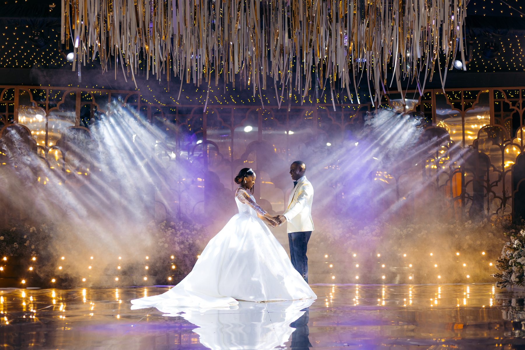 Jordan & Doria — first dance beneath the gold ribbon canopy at Serena Hotel, Dar es Salaam, by Kevins Events
